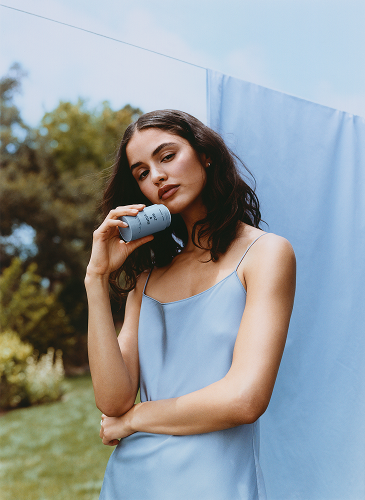 Woman holding Salt & Stone Ambrette and Pear fragrance
