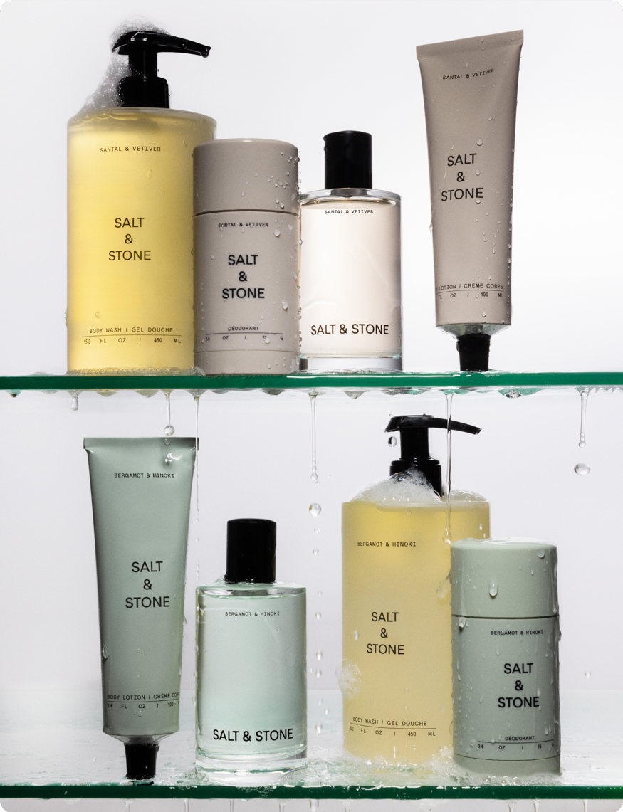 Salt & Stone body care assortment arranged on glass shelves